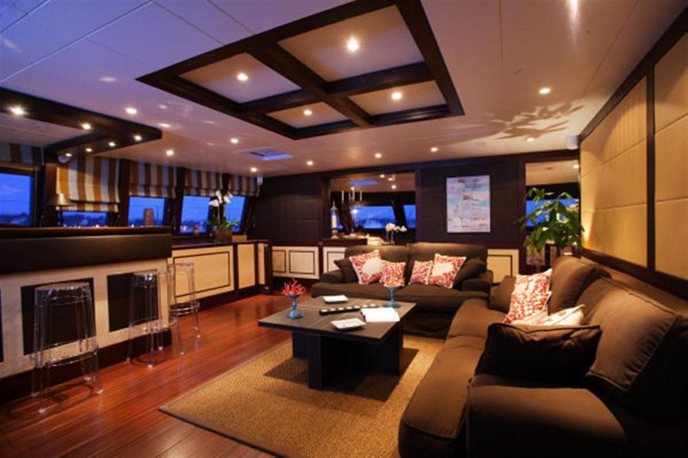 a living room with a fireplace aboard 102' 2007 BLUBAY 102 Yacht for Sale