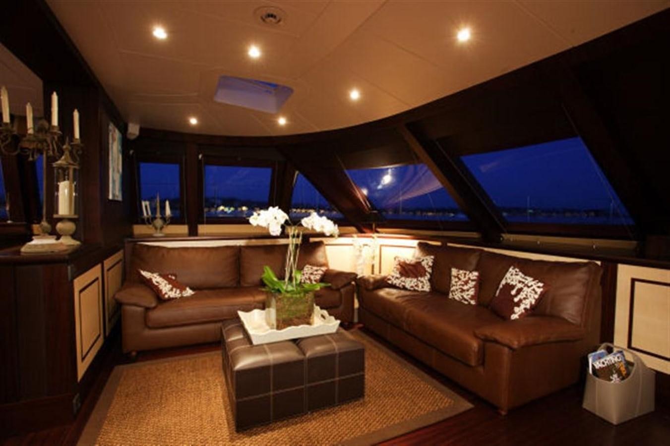 a living room with a large screen aboard 102' 2007 BLUBAY 102 Yacht for Sale