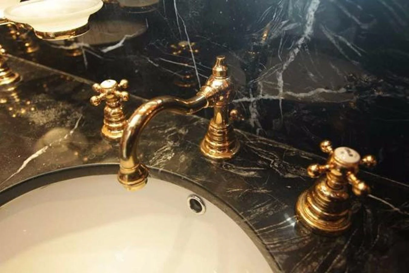 a group of gold statues on a sink aboard GIHRAMAR Yacht for Sale
