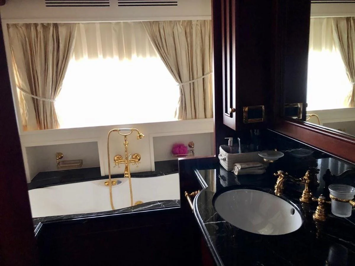 a bathroom with a sink and a mirror aboard GIHRAMAR Yacht for Sale