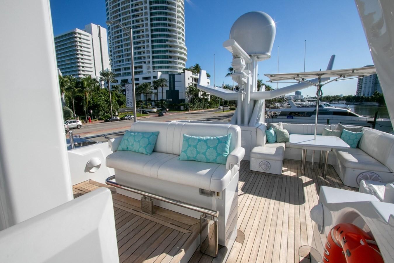 a deck with a pool and a large building with a beach and water aboard HIGH LINE Yacht for Sale
