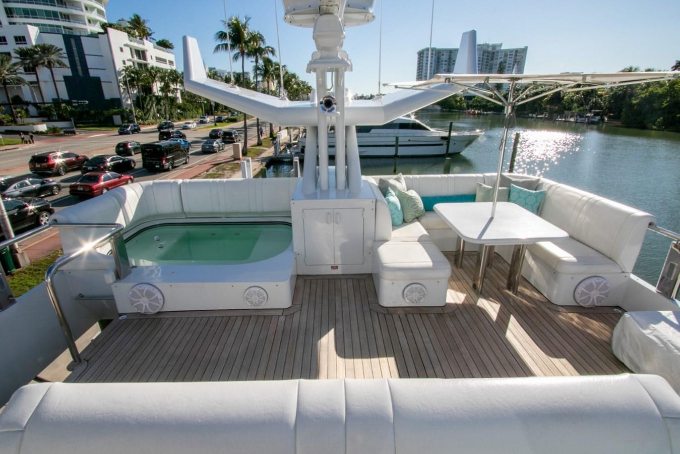 a deck with a pool and a boat in the water aboard HIGH LINE Yacht for Sale