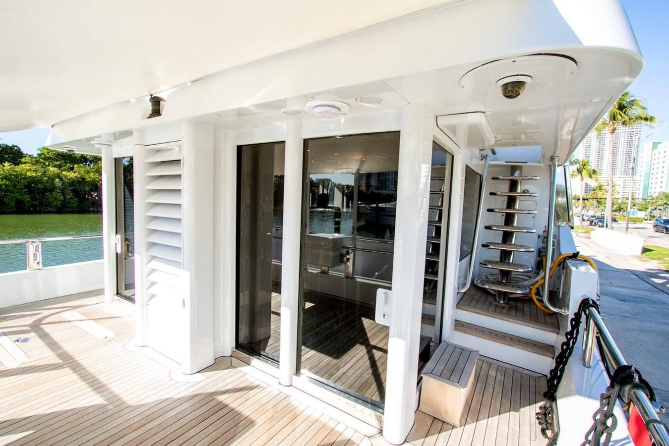 a white house with a deck and a pool aboard HIGH LINE Yacht for Sale