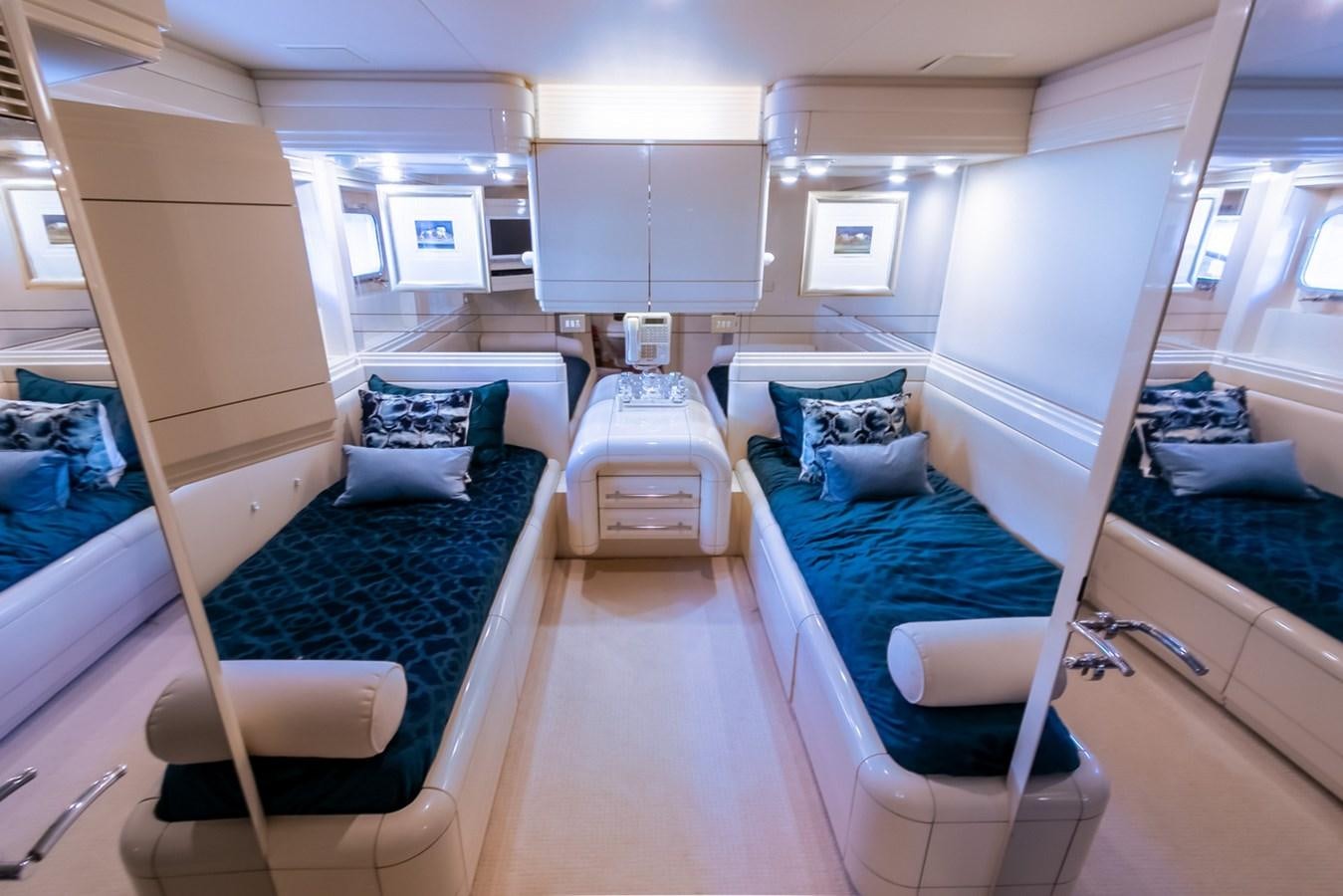 a room with beds and a tv aboard HIGH LINE Yacht for Sale