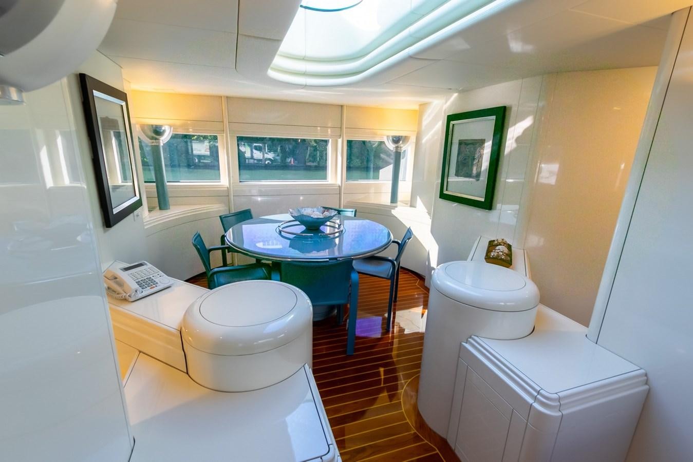a small kitchen with a table and chairs aboard HIGH LINE Yacht for Sale
