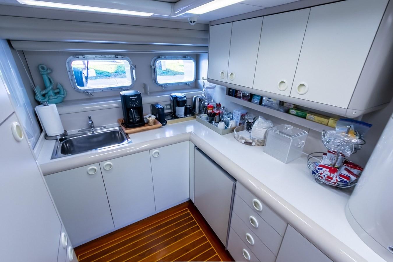 a kitchen with white cabinets aboard HIGH LINE Yacht for Sale