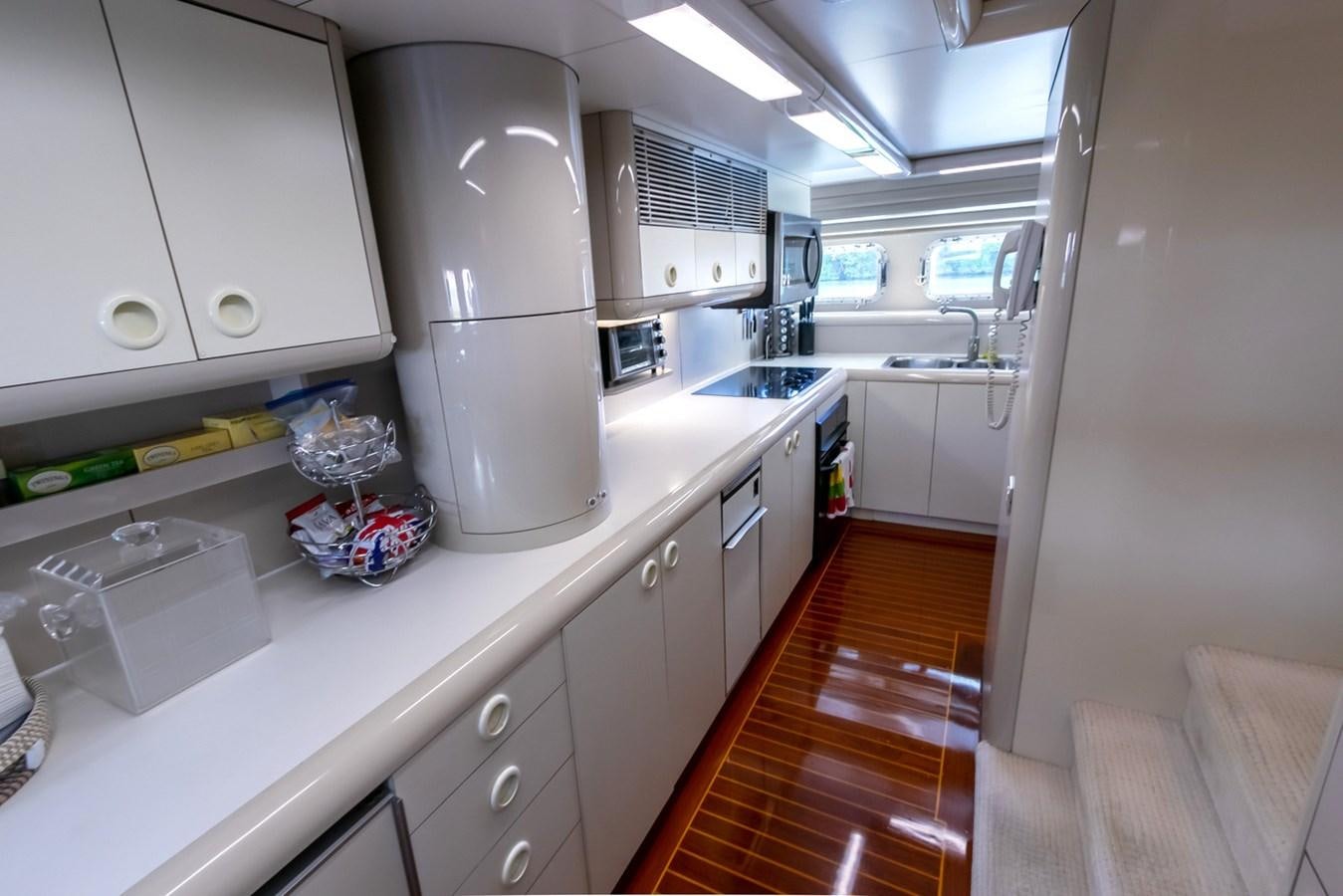 a kitchen with white cabinets aboard HIGH LINE Yacht for Sale