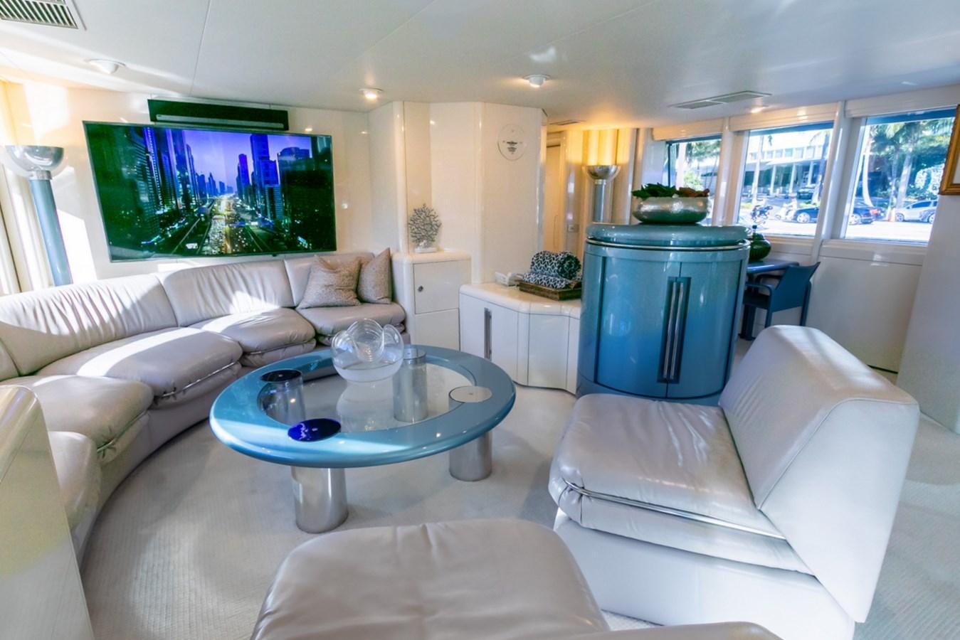 a living room with a blue table aboard HIGH LINE Yacht for Sale