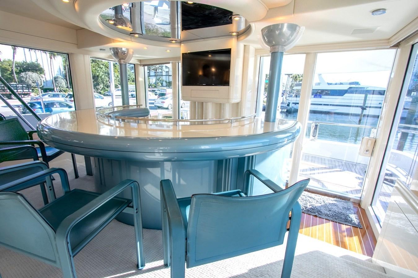 a table with chairs around it aboard HIGH LINE Yacht for Sale