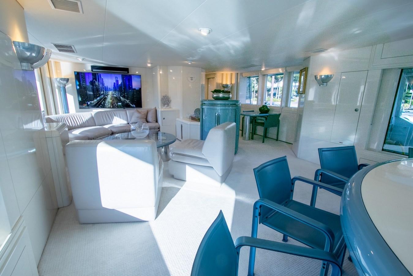 a room with a table chairs and a tv aboard HIGH LINE Yacht for Sale