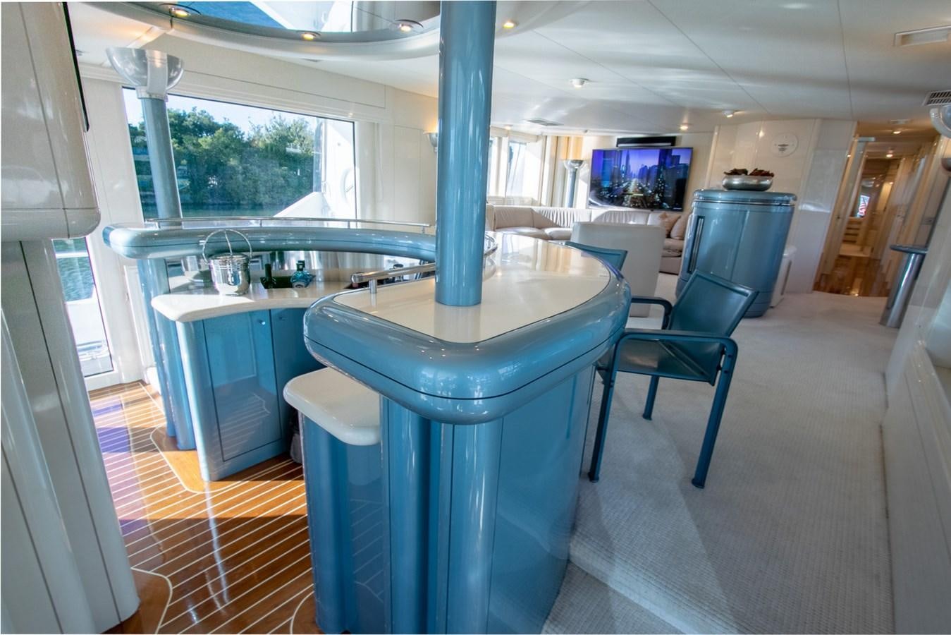 a kitchen with a bar and stools aboard HIGH LINE Yacht for Sale
