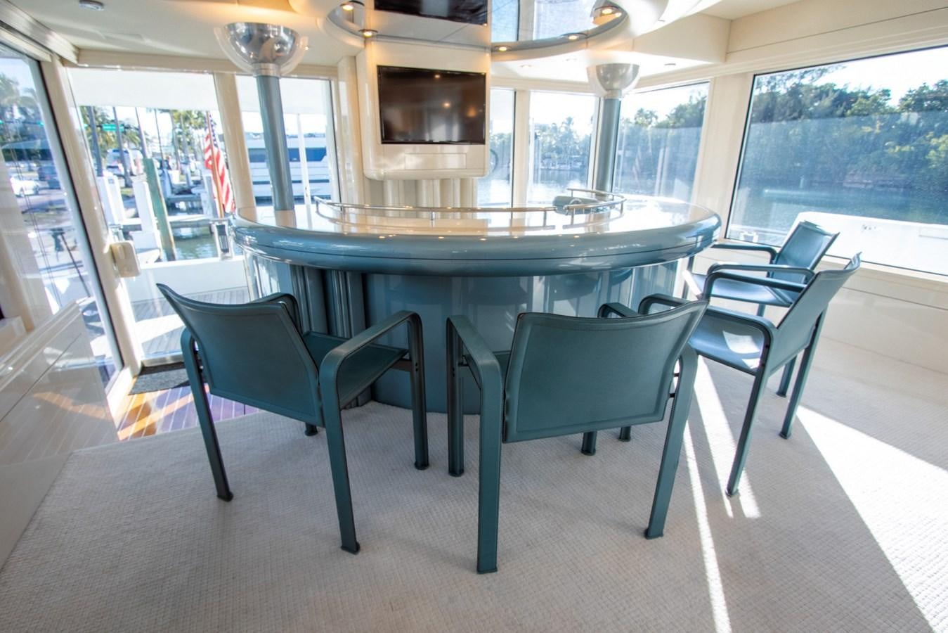a table and chairs in a room aboard HIGH LINE Yacht for Sale
