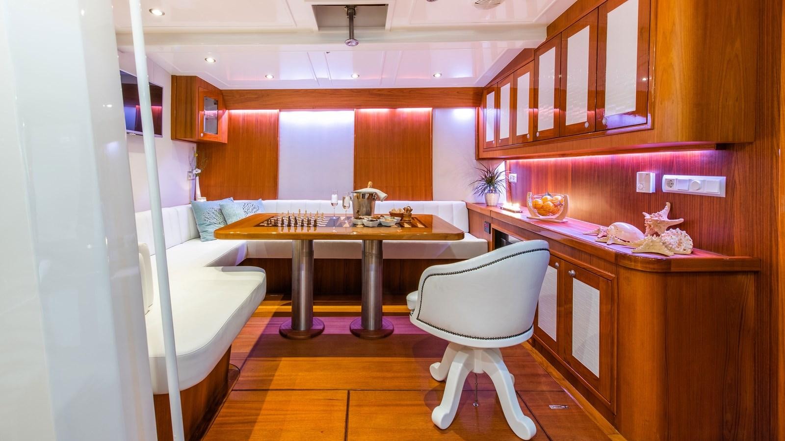 a room with a table and chairs aboard BORKUMRIFF II Yacht for Sale