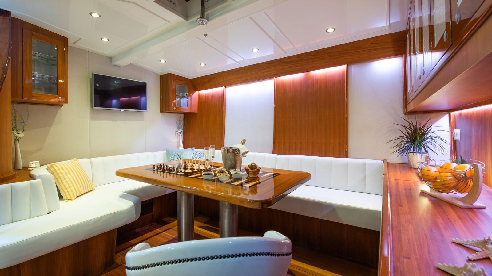 a room with a table and chairs aboard BORKUMRIFF II Yacht for Sale
