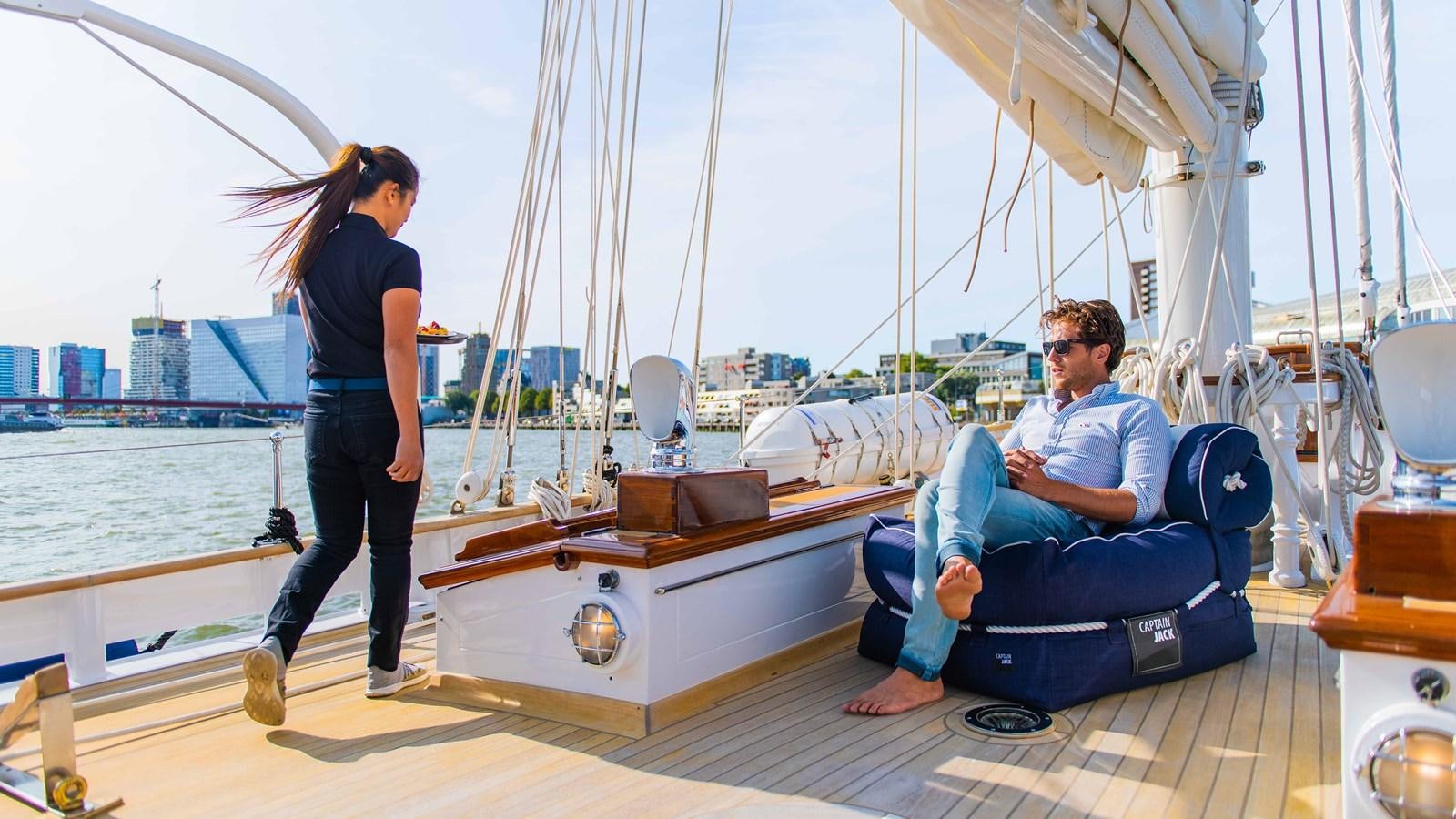a man and woman sitting on a boat aboard BORKUMRIFF II Yacht for Sale