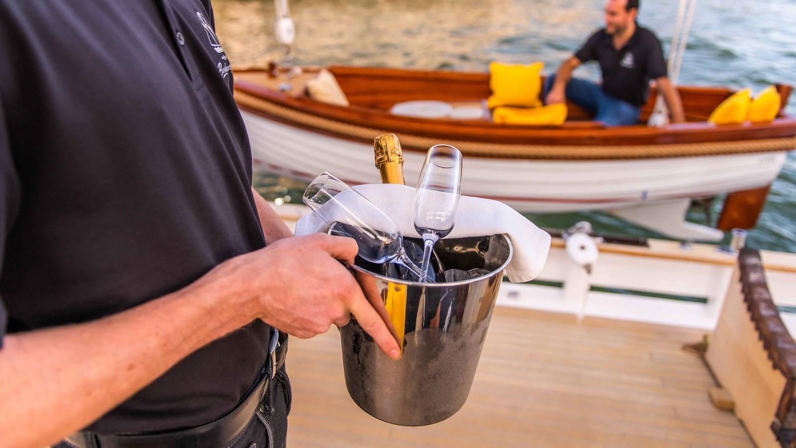 a man pouring a glass of water aboard BORKUMRIFF II Yacht for Sale