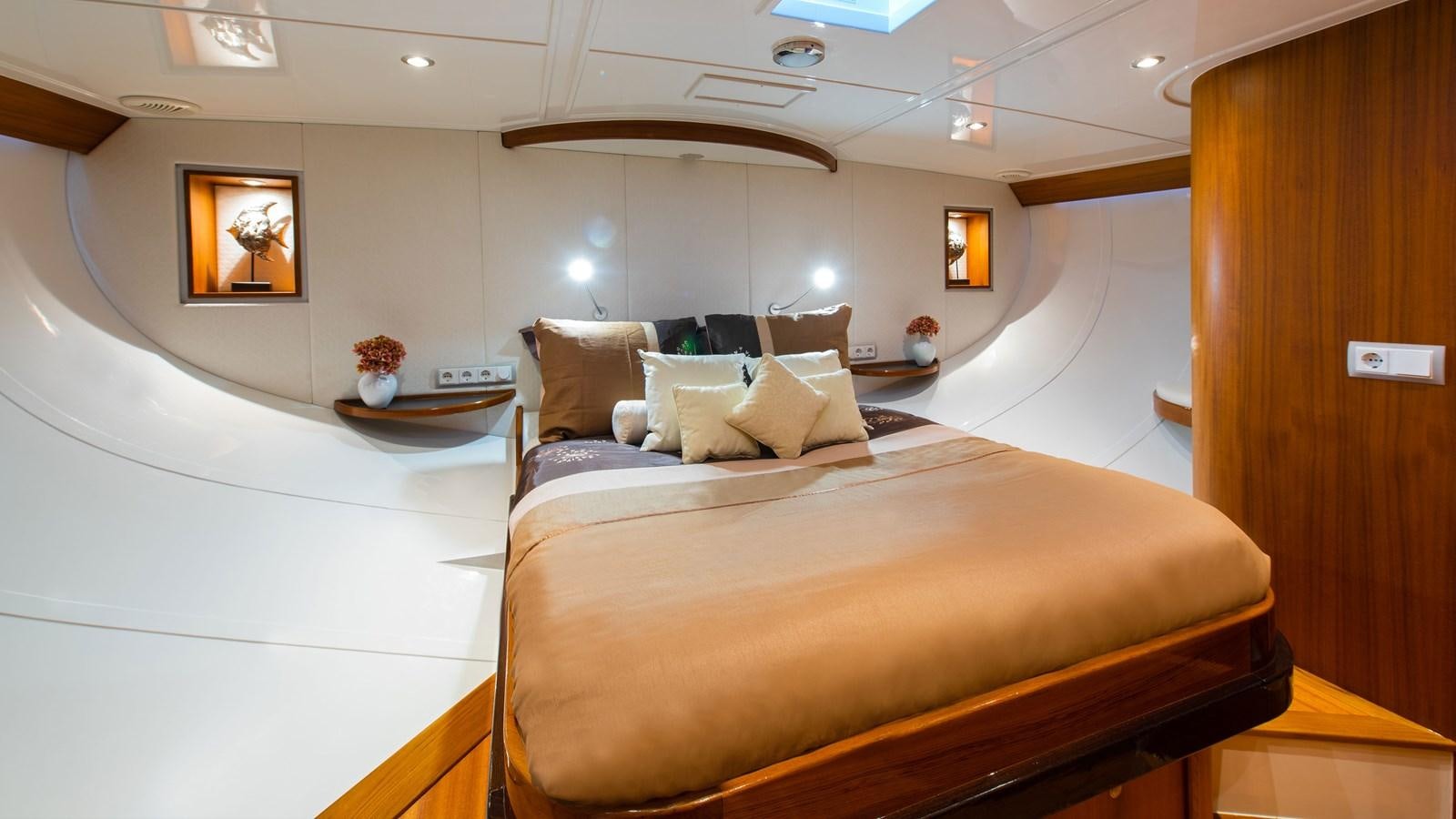 a bed with a white bed spread aboard BORKUMRIFF II Yacht for Sale