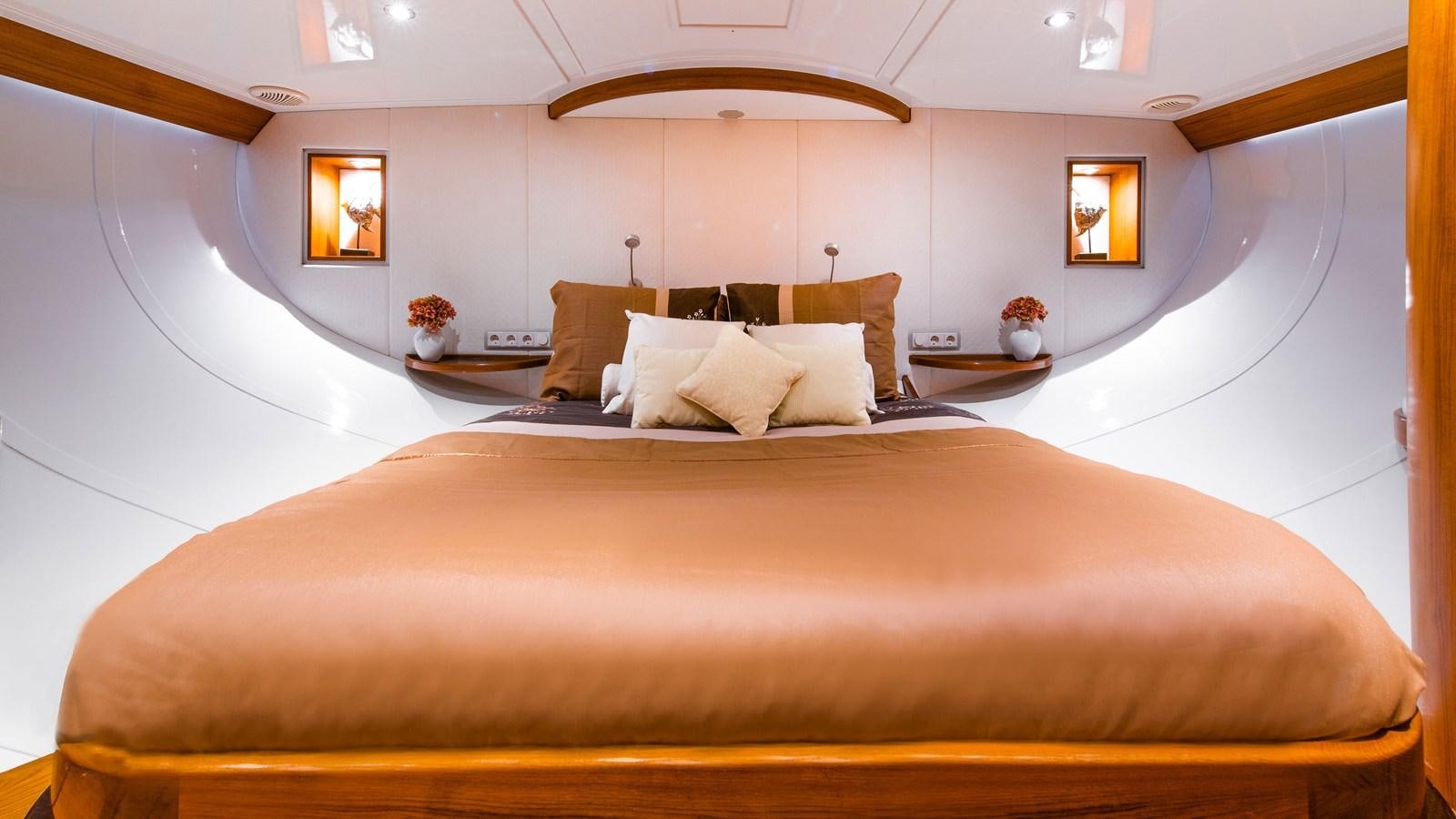 a bed with a white bed spread aboard BORKUMRIFF II Yacht for Sale
