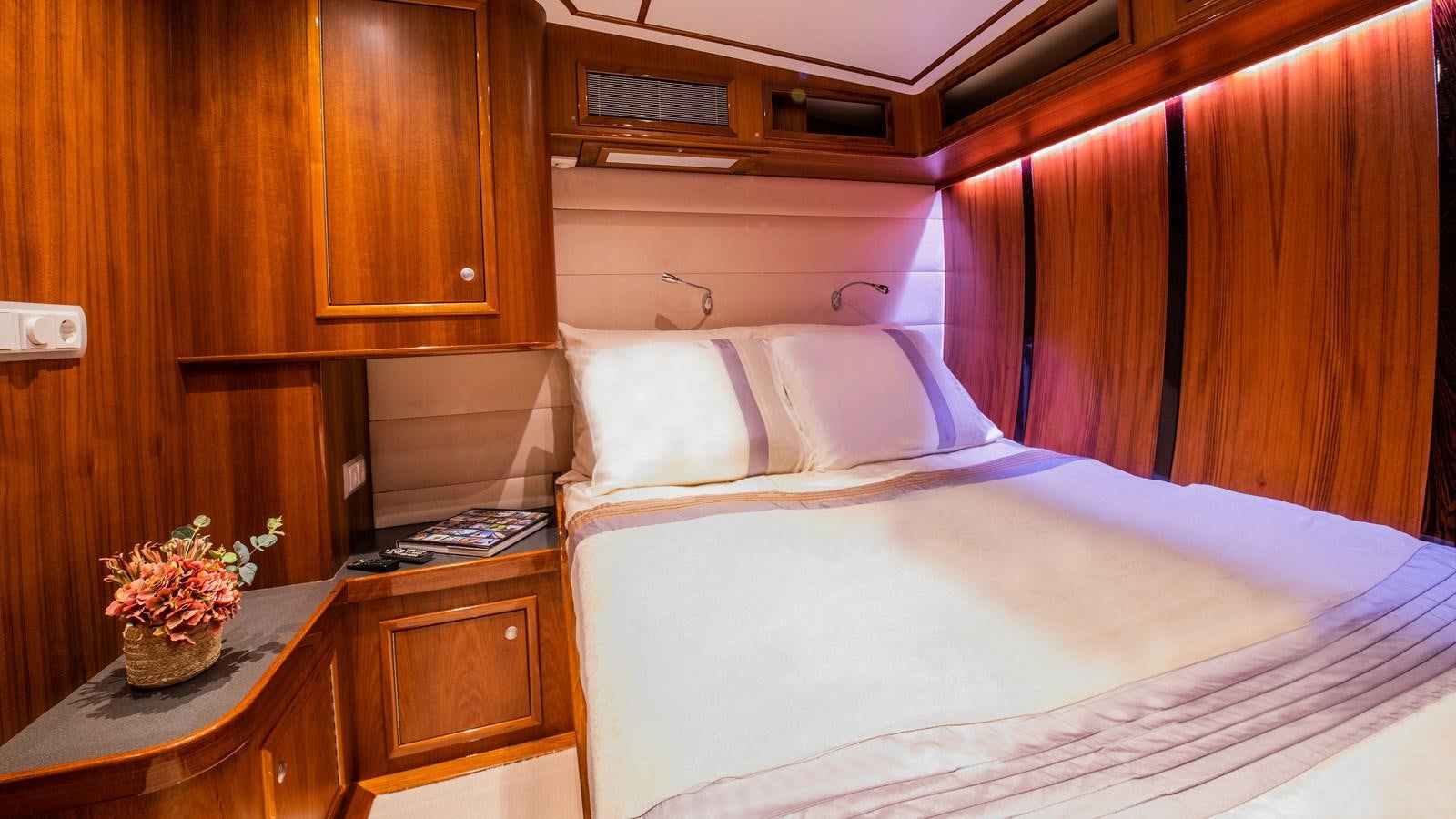 a bed with a flower pot on top of it aboard BORKUMRIFF II Yacht for Sale