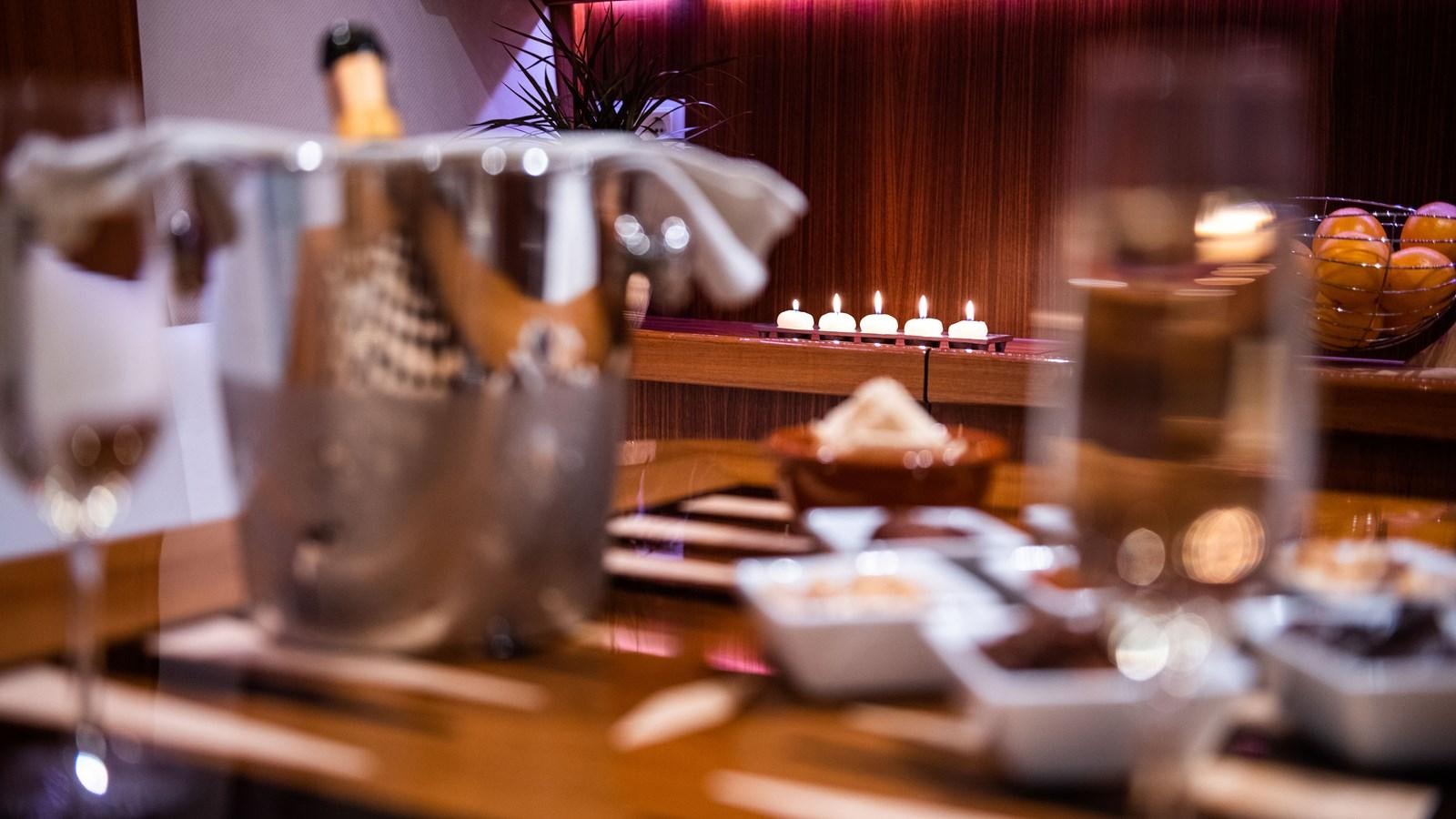 a table with food and candles aboard BORKUMRIFF II Yacht for Sale