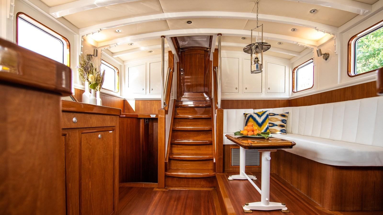 a room with a bed and a table aboard BORKUMRIFF II Yacht for Sale