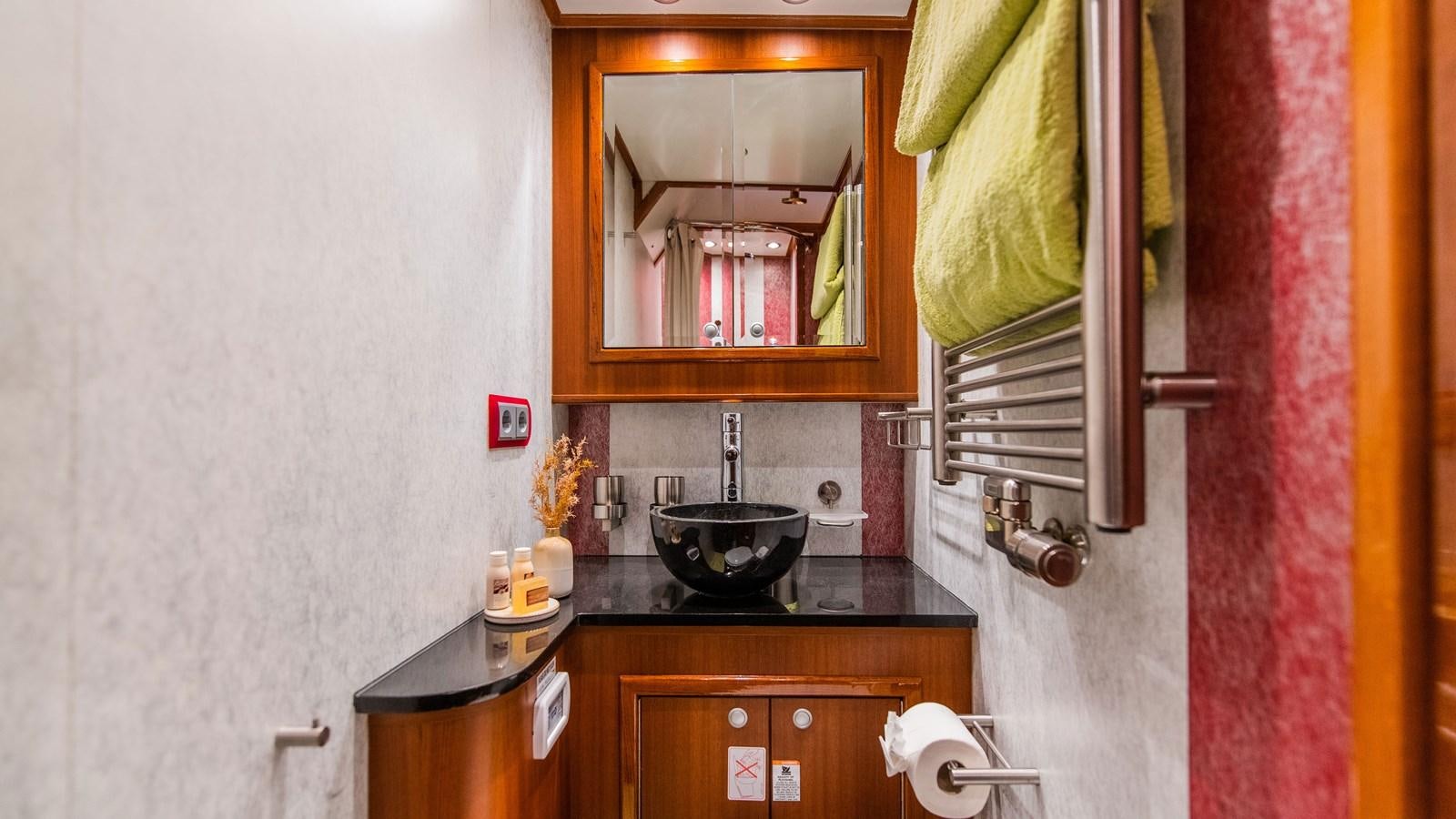 a bathroom with a sink and a mirror aboard BORKUMRIFF II Yacht for Sale