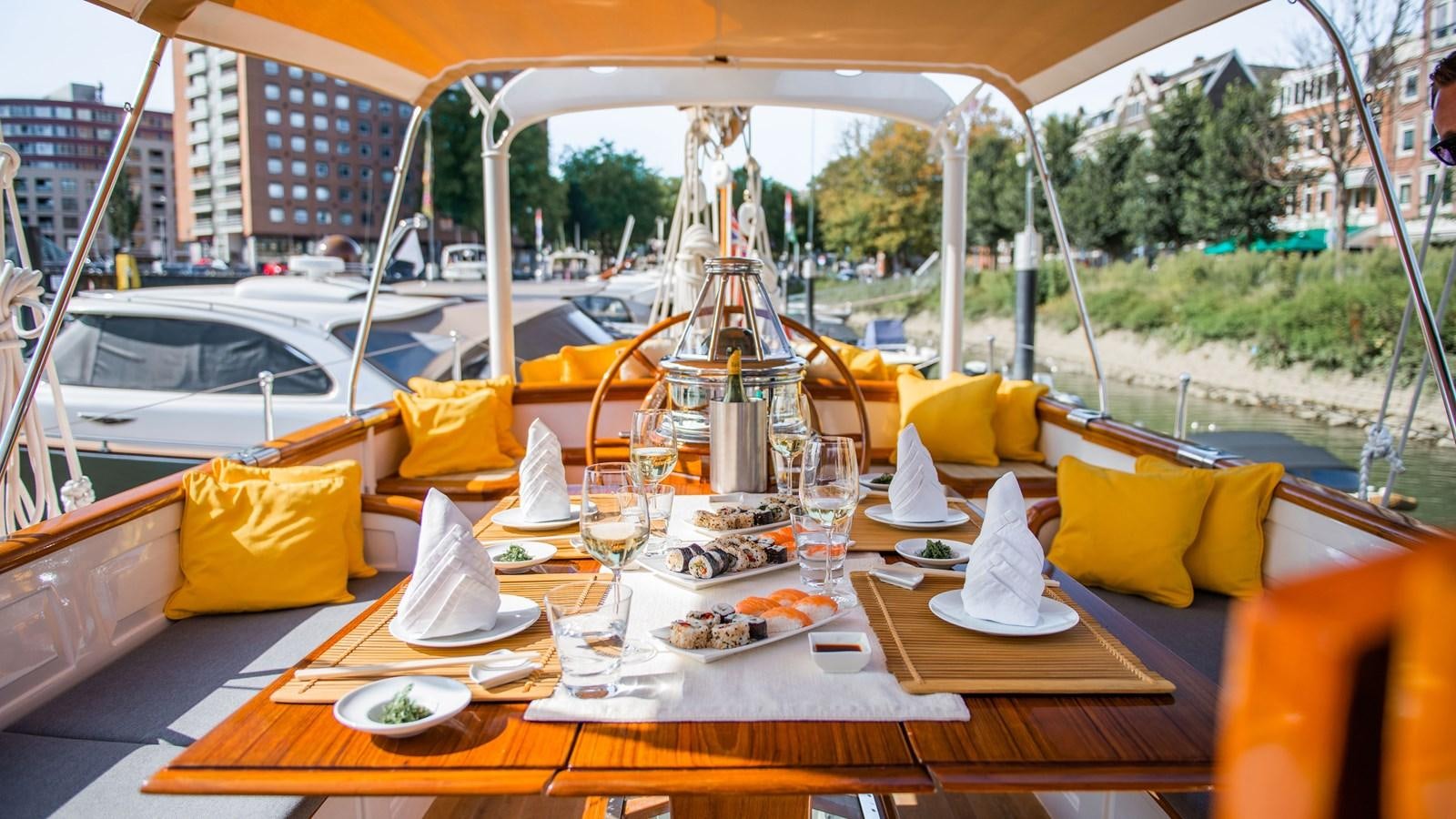 a table with food and drinks on it aboard BORKUMRIFF II Yacht for Sale