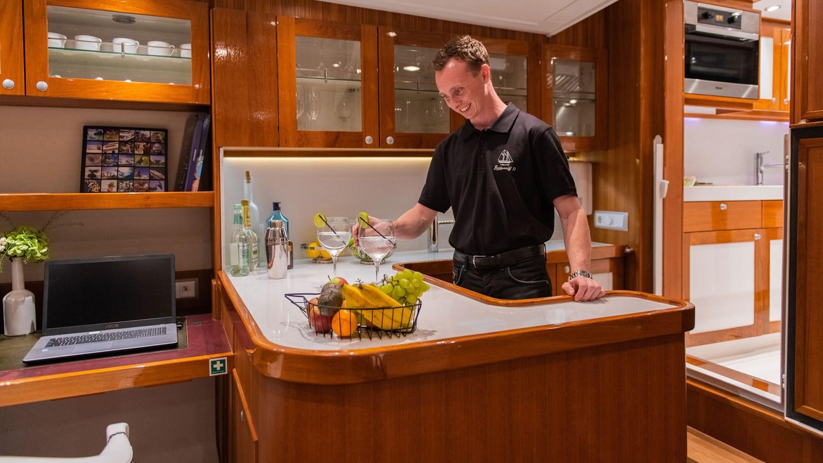 a person standing in a kitchen aboard BORKUMRIFF II Yacht for Sale