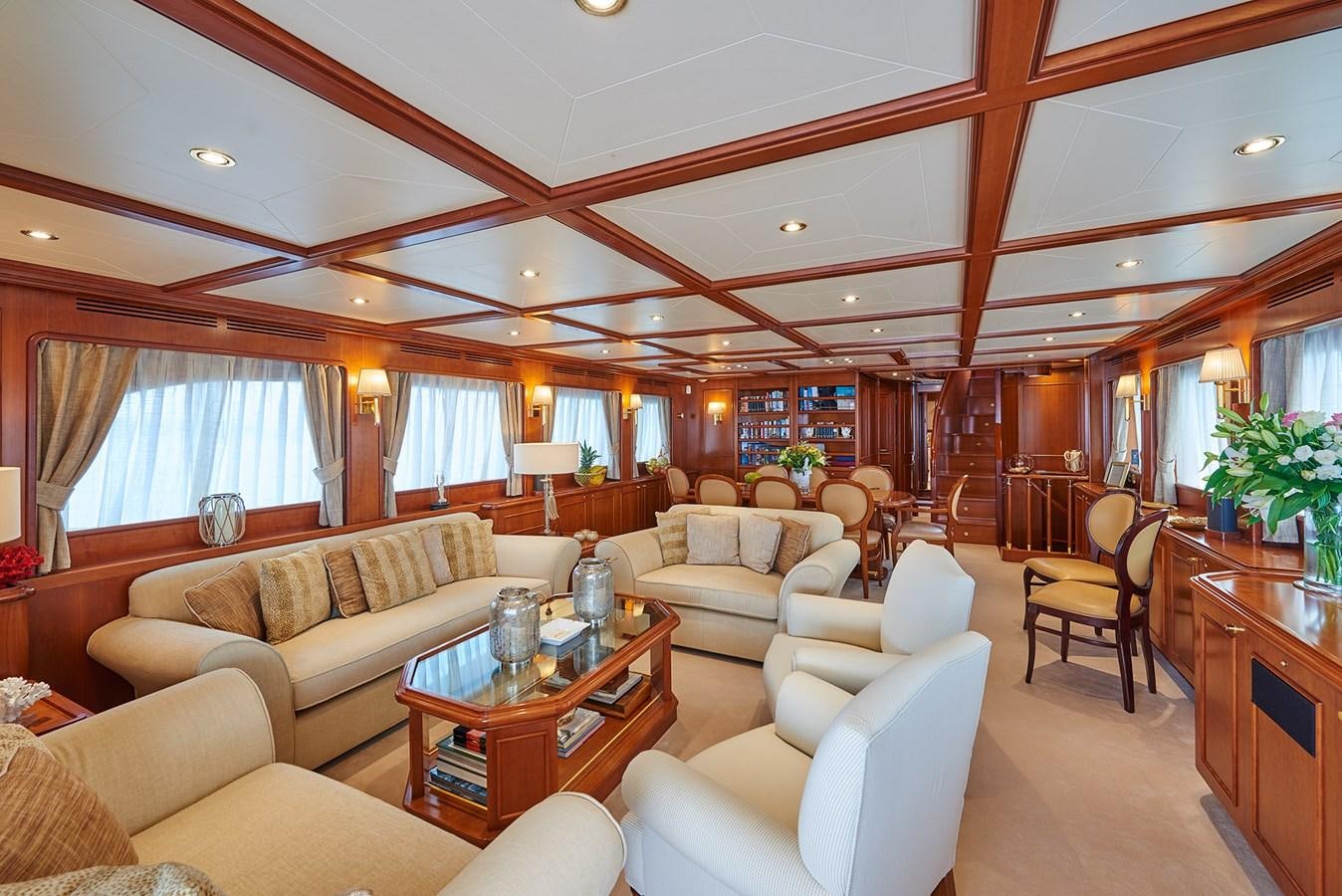 a living room with a couch and a coffee table aboard IMAGINE Yacht for Charter