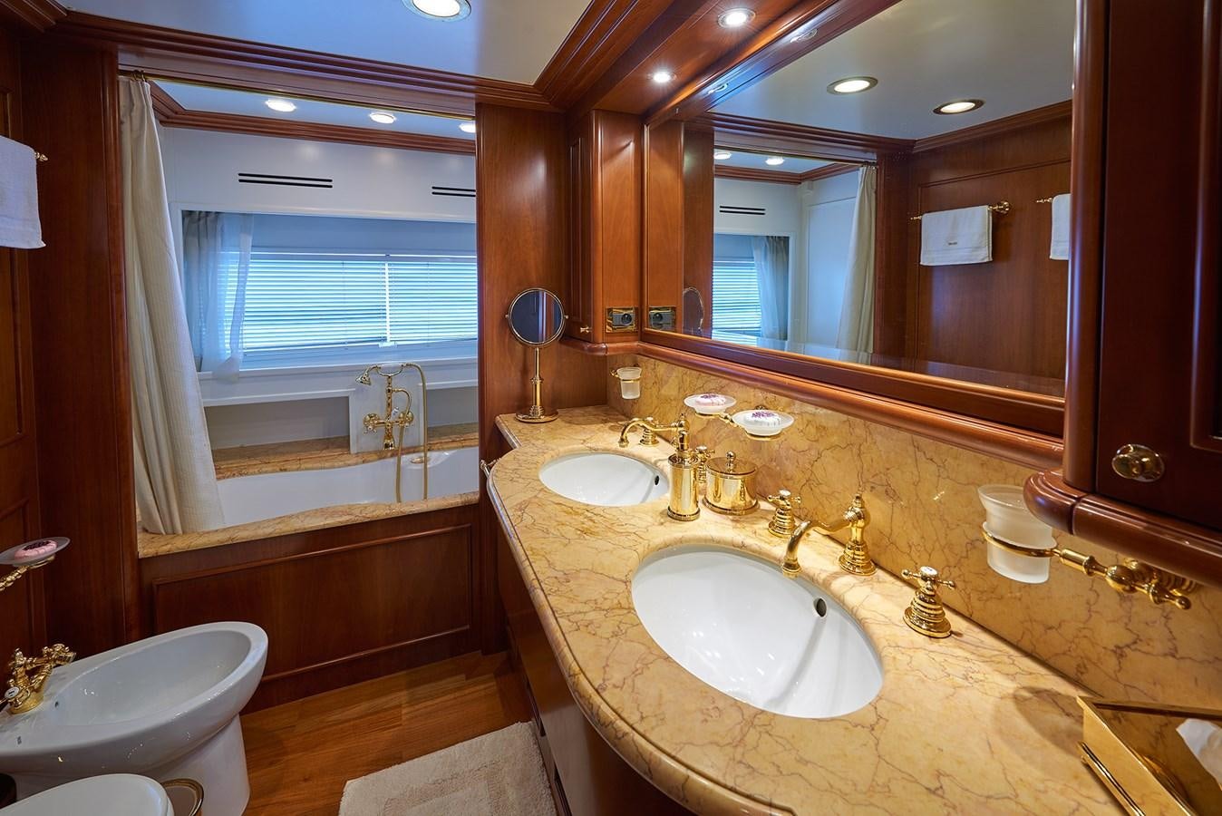 a bathroom with two sinks and a large mirror aboard IMAGINE Yacht for Sale