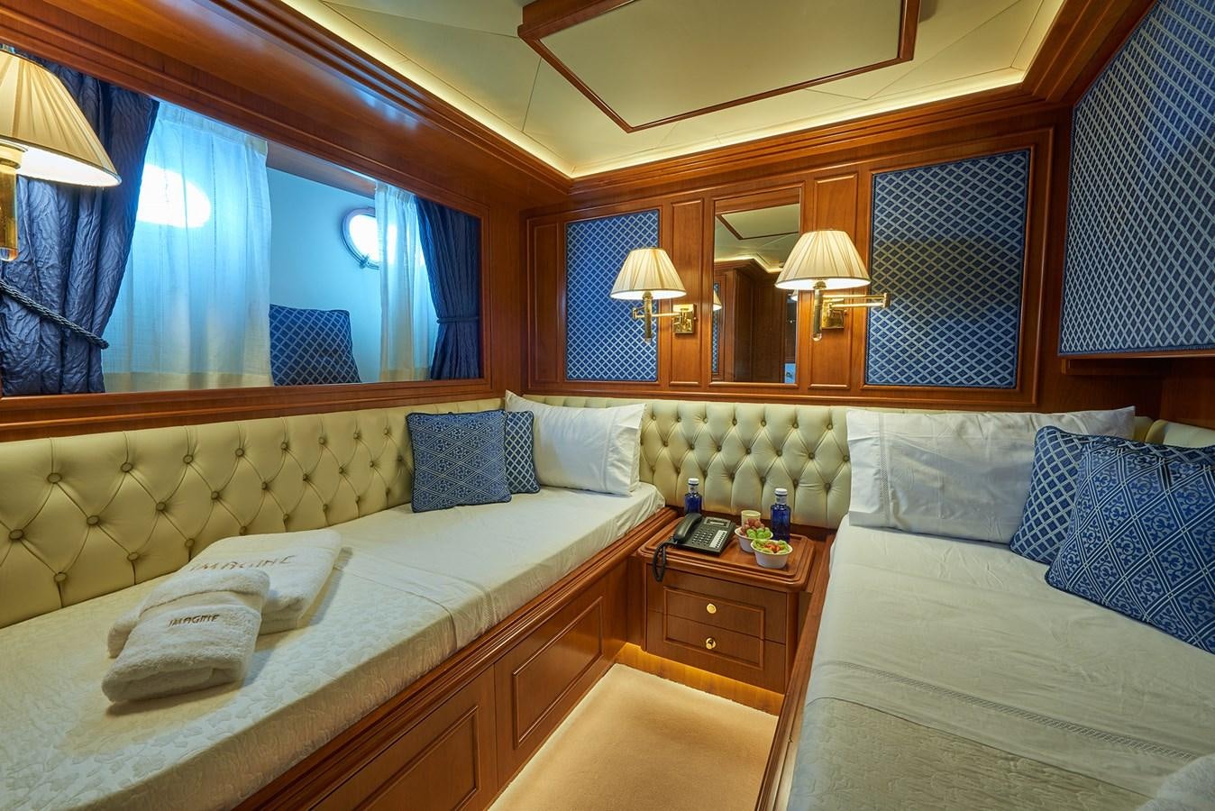 a room with two beds aboard IMAGINE Yacht for Charter
