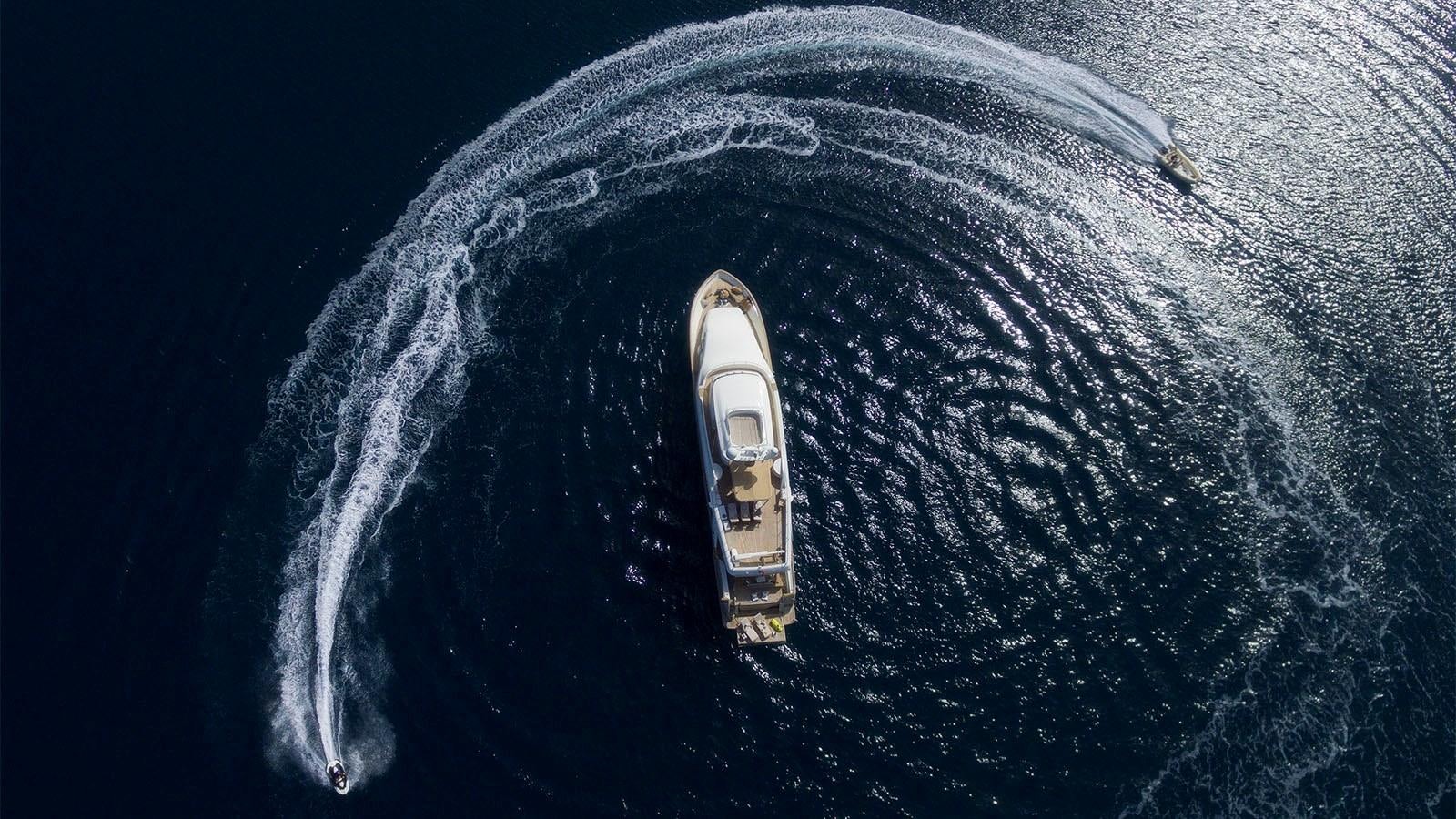 a silver and gold watch on a blue surface aboard IMAGINE Yacht for Sale