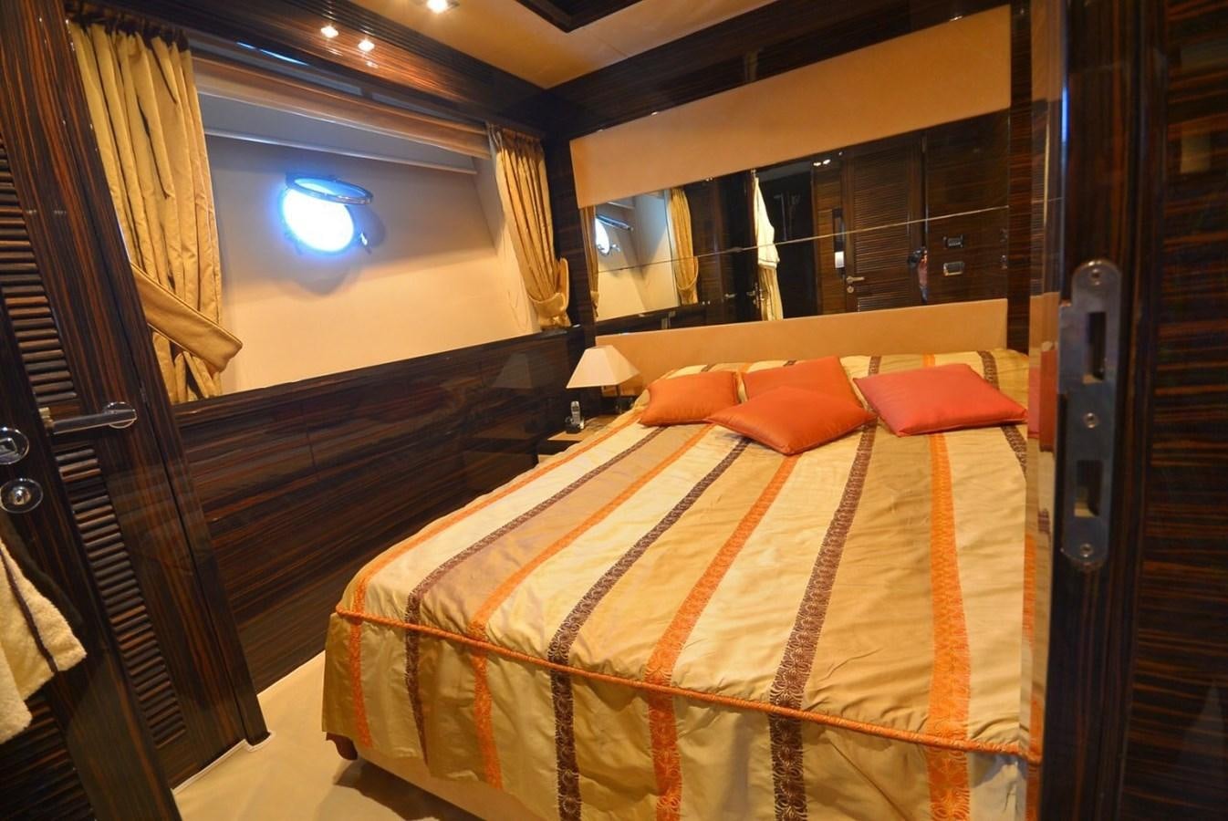 a room with a bed and a window aboard JULIA DOROTHY Yacht for Sale