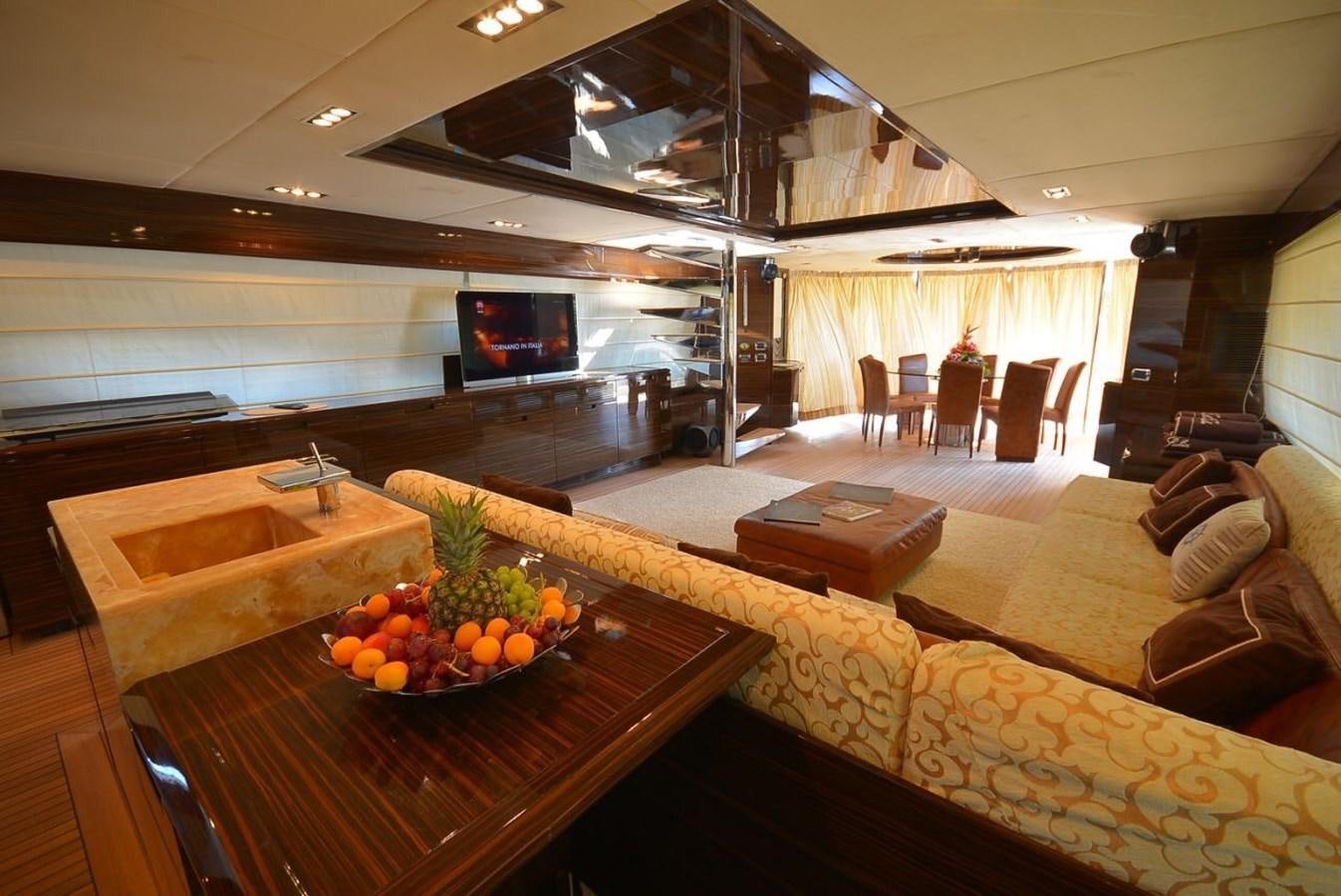 a room with a table and couches aboard JULIA DOROTHY Yacht for Sale