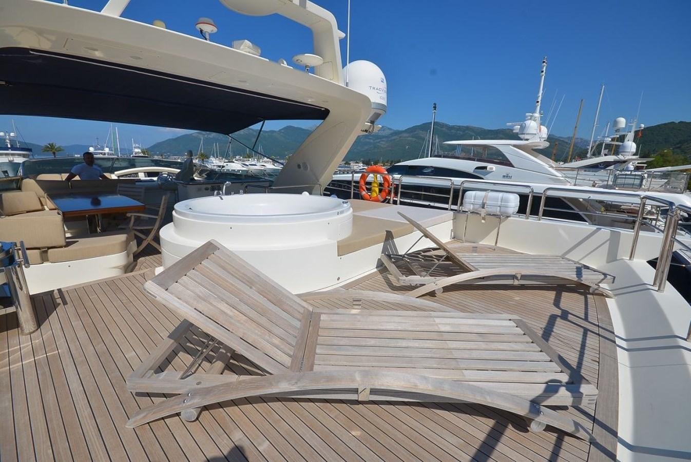 a deck with chairs and boats aboard JULIA DOROTHY Yacht for Sale