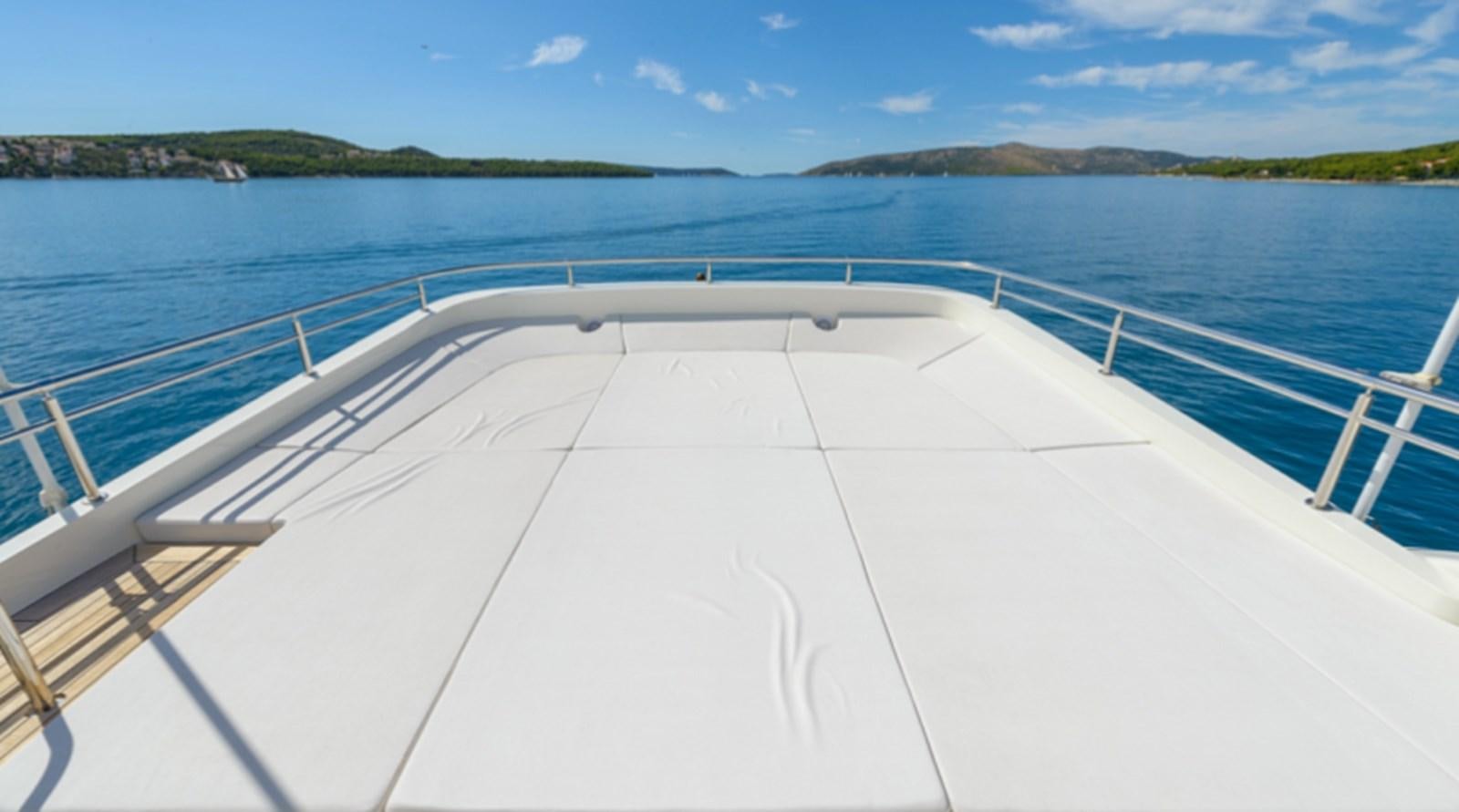 a white boat on a body of water aboard NOVELA Yacht for Charter