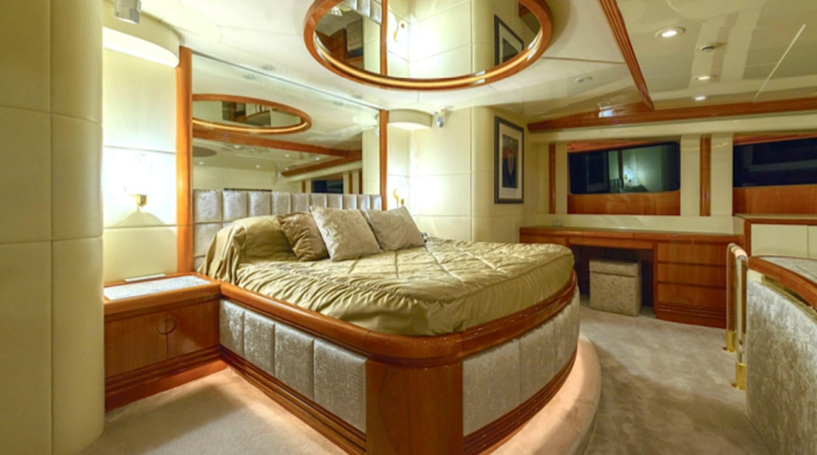 a room with a bed and a mirror aboard NOVELA Yacht for Charter