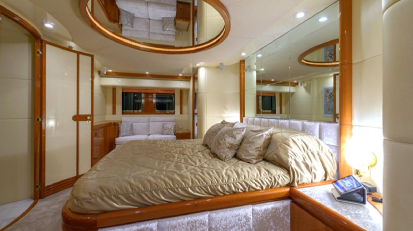 a bed with a mirror above it aboard NOVELA Yacht for Charter