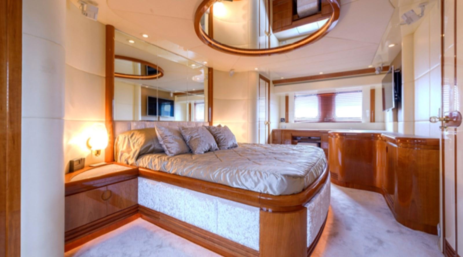 a bedroom with a bed and a mirror aboard NOVELA Yacht for Charter