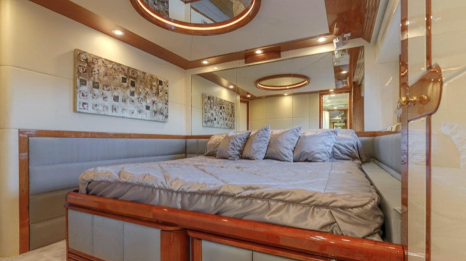 a bed with a blue comforter aboard NOVELA Yacht for Charter