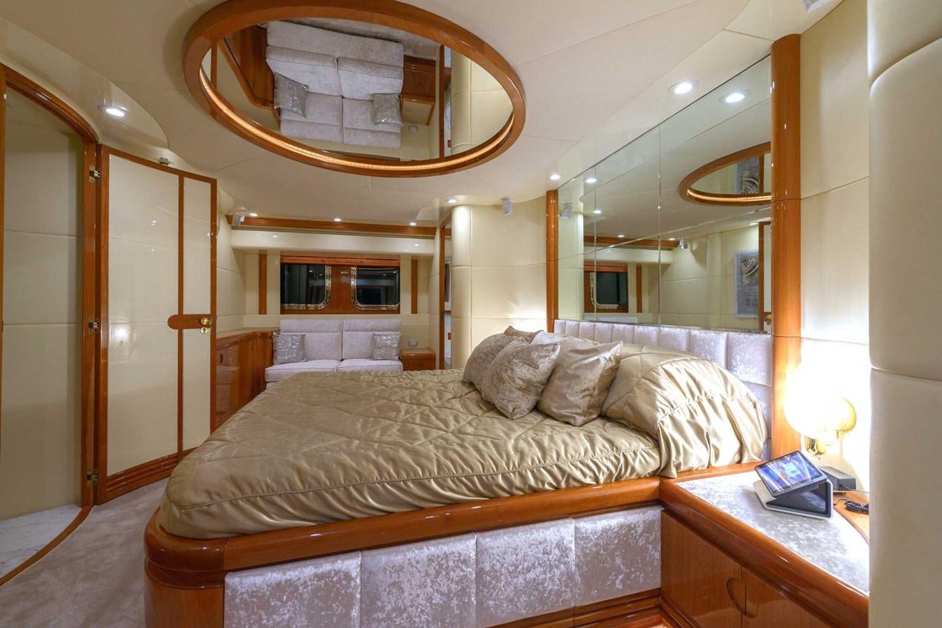 a bed with a mirror above it aboard NOVELA Yacht for Sale