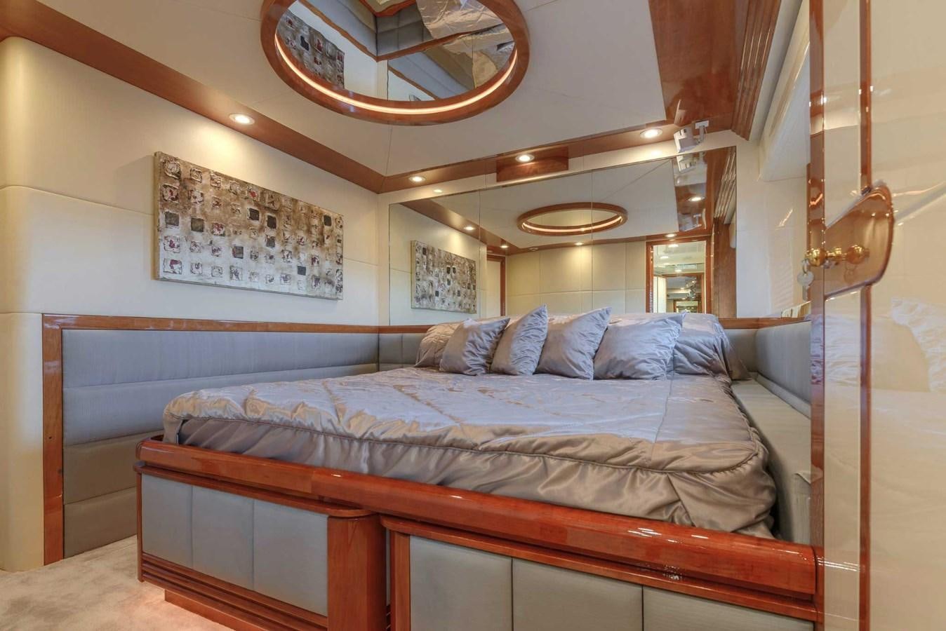 a bed with a wooden headboard aboard NOVELA Yacht for Sale