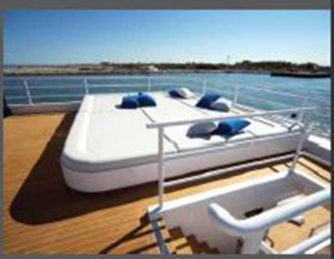 a white boat on a dock aboard OCEAN KING AMERICANA Yacht for Sale