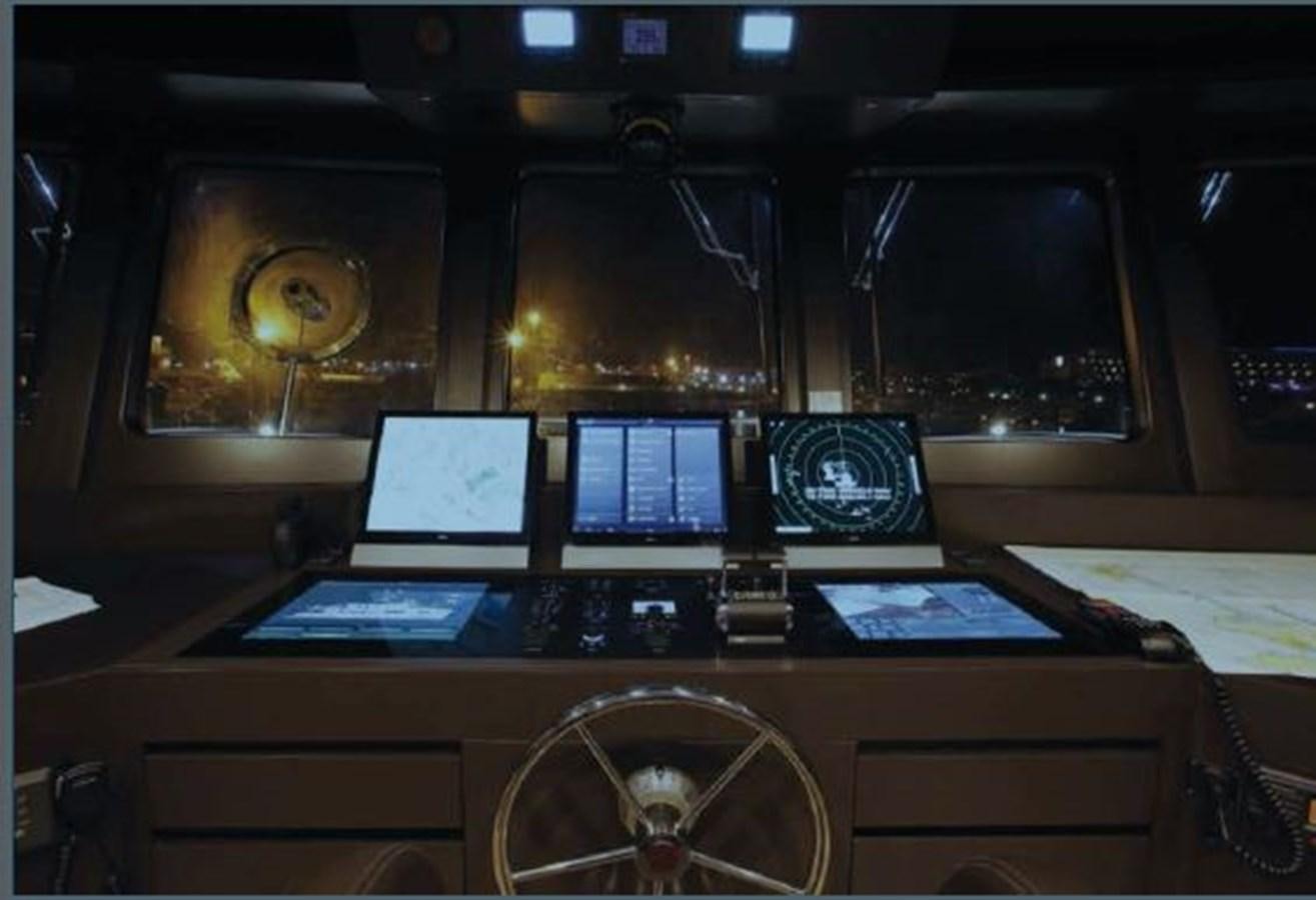 a laptop and a tablet on a table aboard OCEAN KING AMERICANA Yacht for Sale