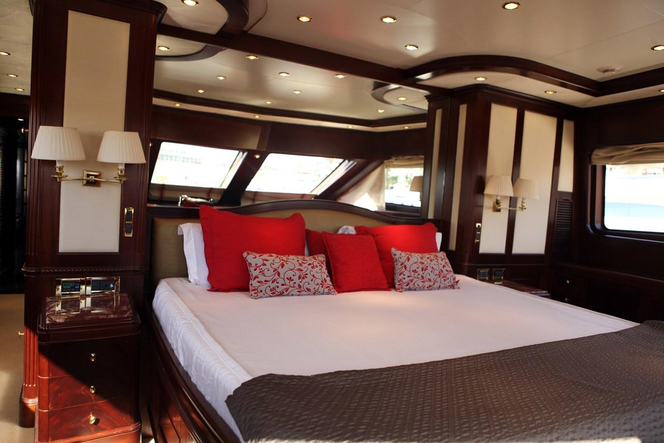 a bed with red pillows aboard ANYPA Yacht for Sale