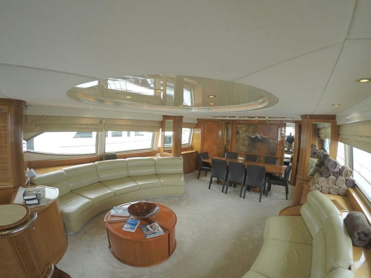 a living room with a large chandelier aboard AZIMUT 100' Yacht for Sale