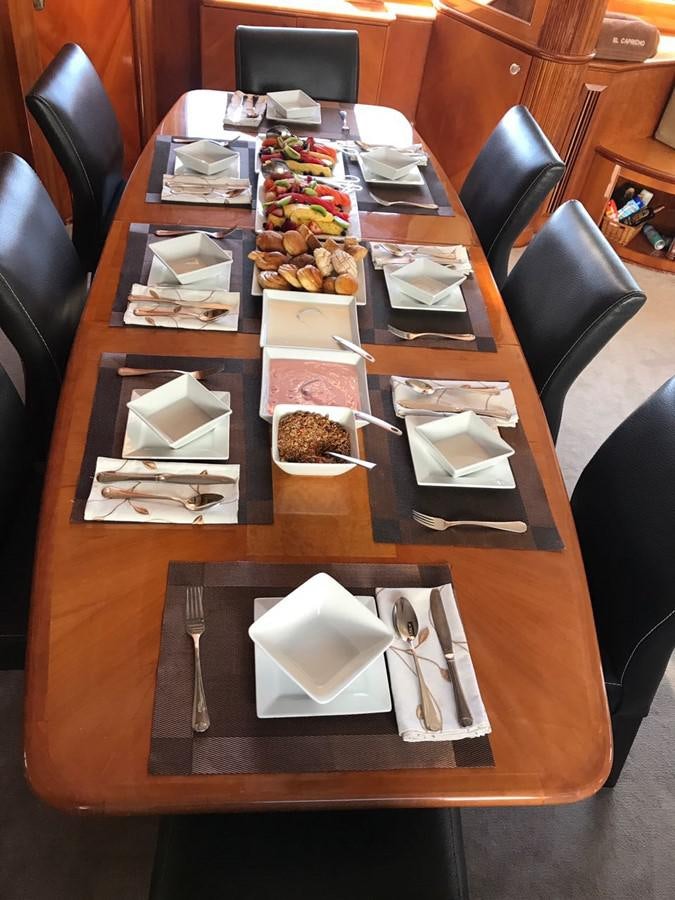 a table with plates and napkins aboard AZIMUT 100' Yacht for Sale