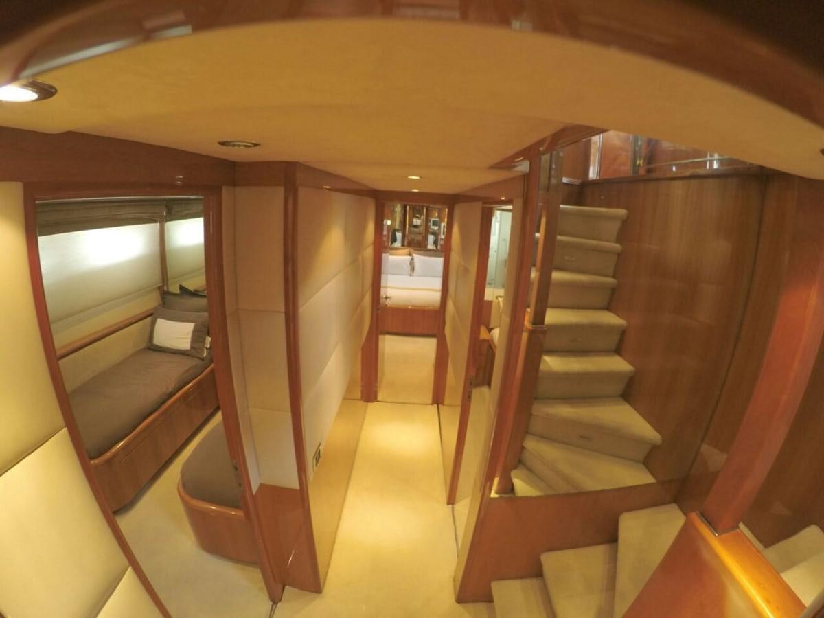 a room with wooden stairs aboard AZIMUT 100' Yacht for Sale