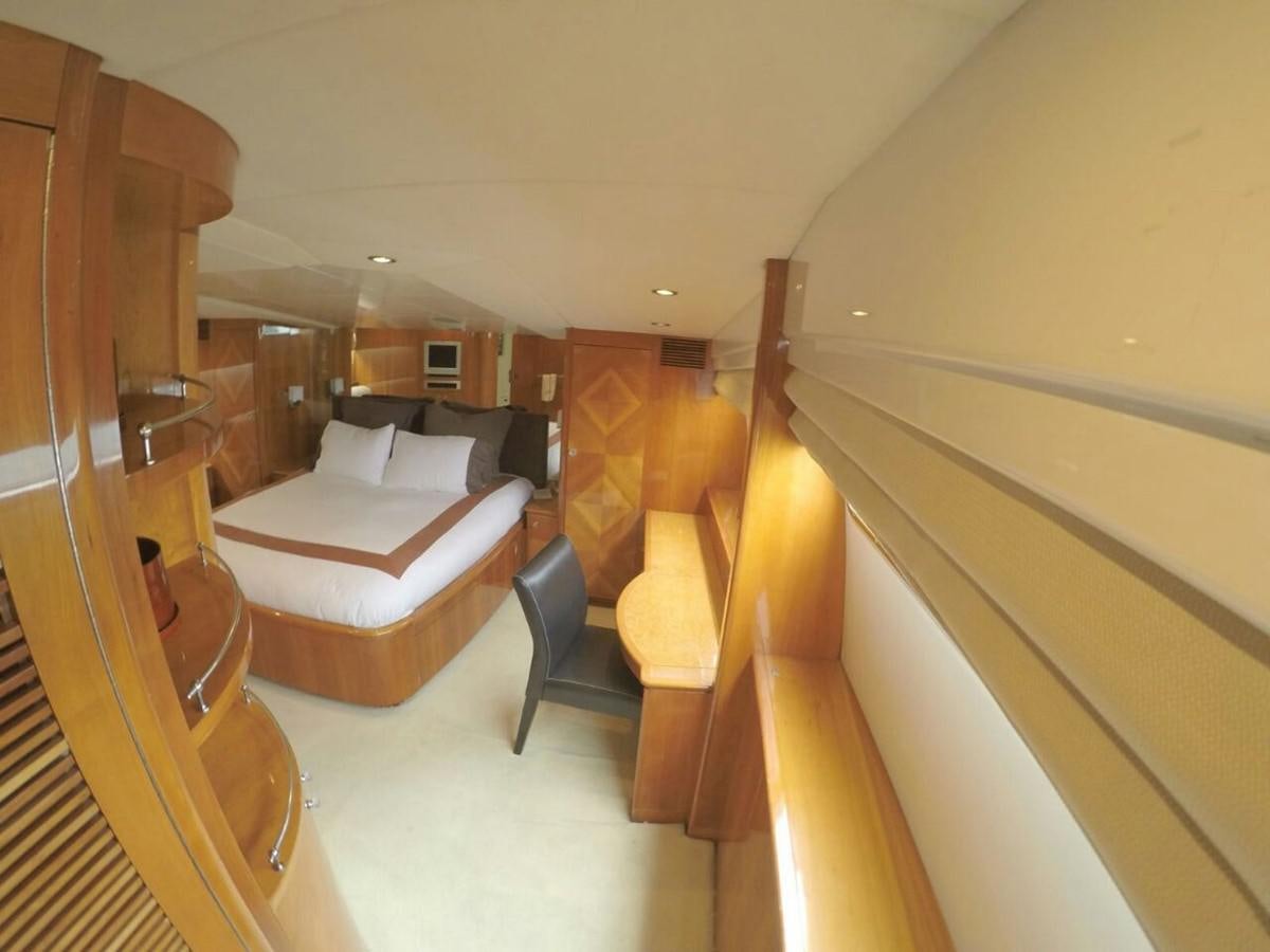 a room with a bed and a chair aboard AZIMUT 100' Yacht for Sale