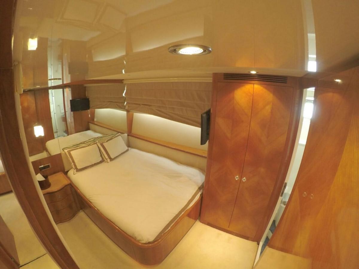 a room with a bed and a closet aboard AZIMUT 100' Yacht for Sale